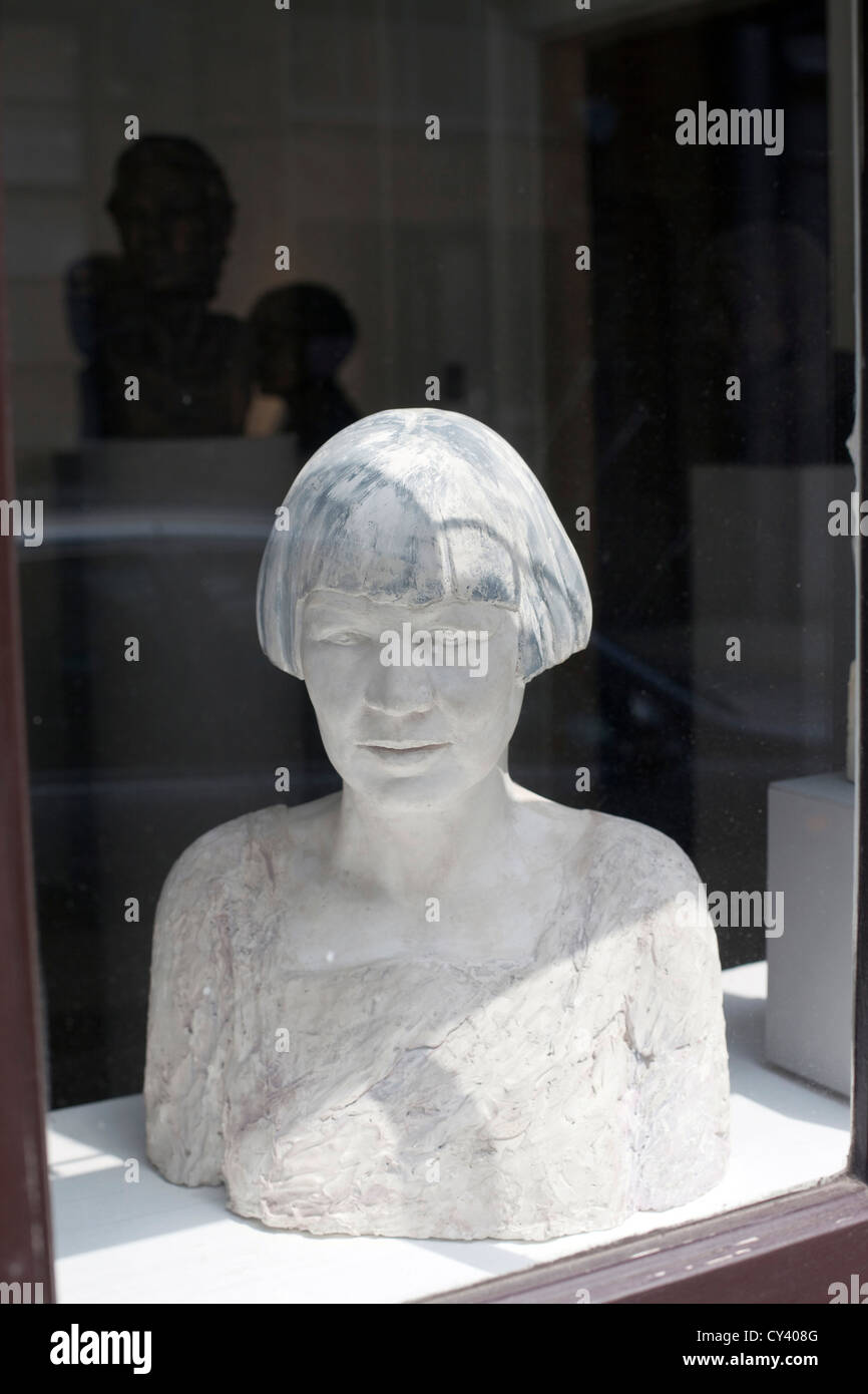 A statue in the window of a shop. Spitalfields. London UK Stock Photo