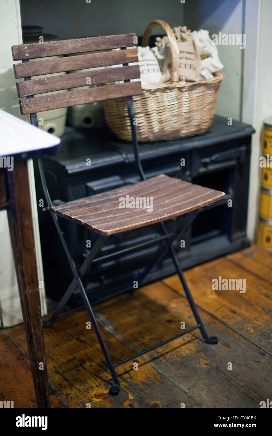 A basket of bread and a chair in A.Gold, a delicatessen in Spitalfields Market, London, UK Stock Photo