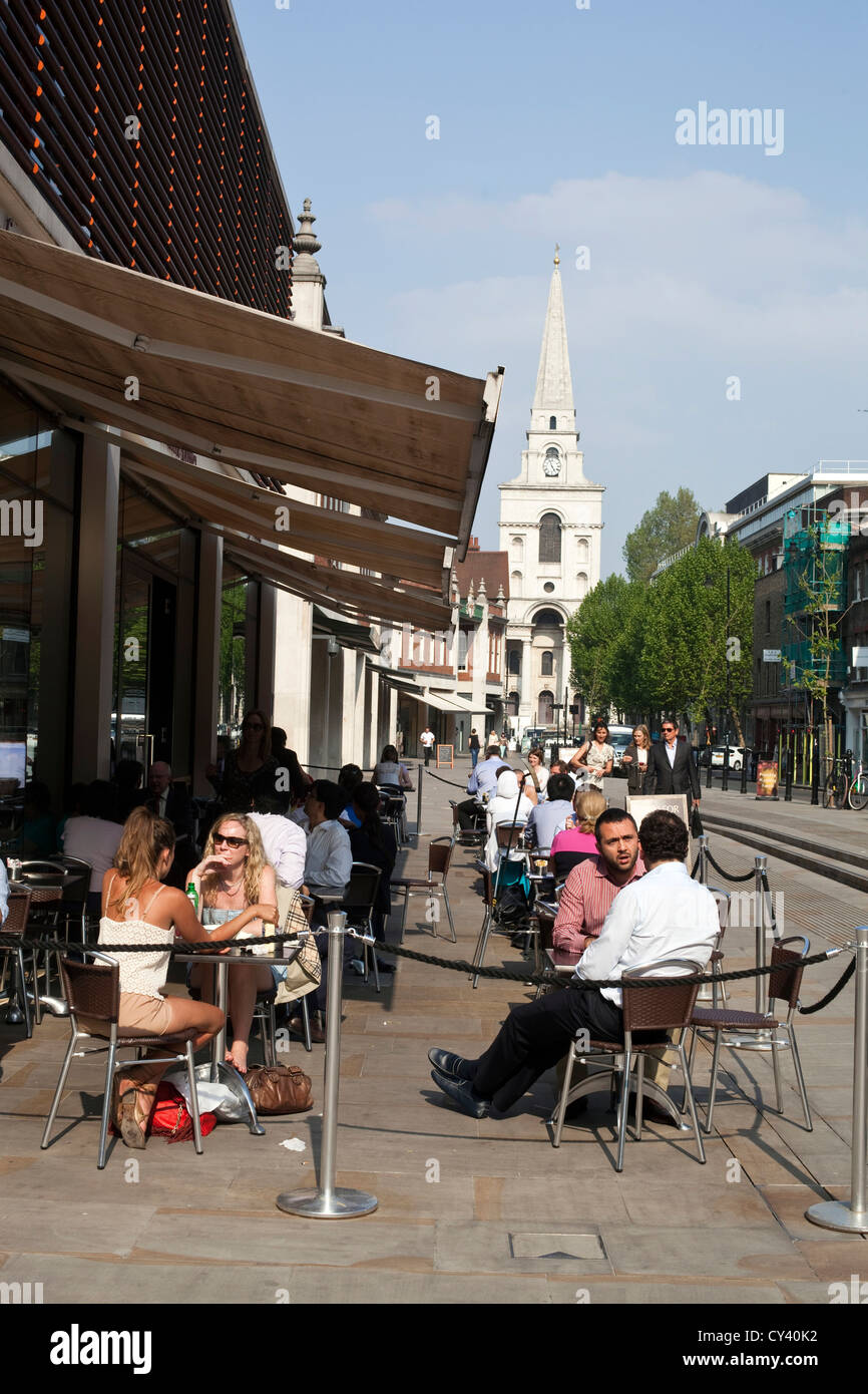 Diners sit outside a cafe at Spitalfields Market, London, UK Stock Photo