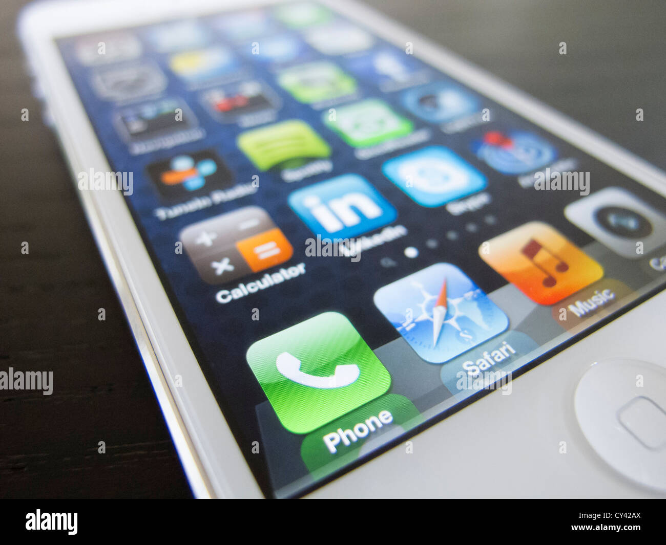 Detail of new iPhone5 smart phone screen showing many homescreen apps Stock Photo