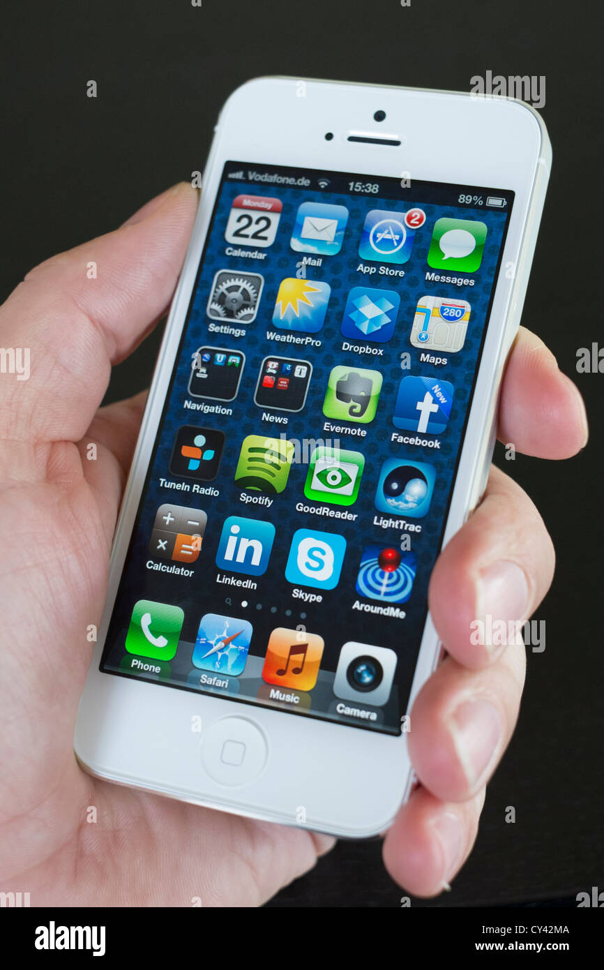 Detail of new iPhone 5 smart phone screen showing many homescreen apps Stock Photo