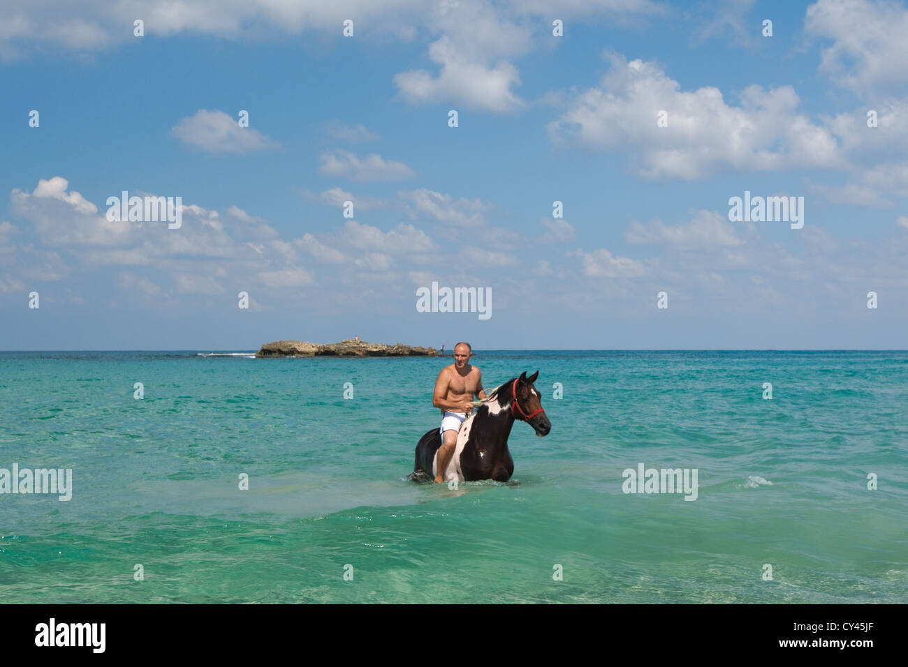 Man Washes his horse in the Mediterranean Sea Stock Photo