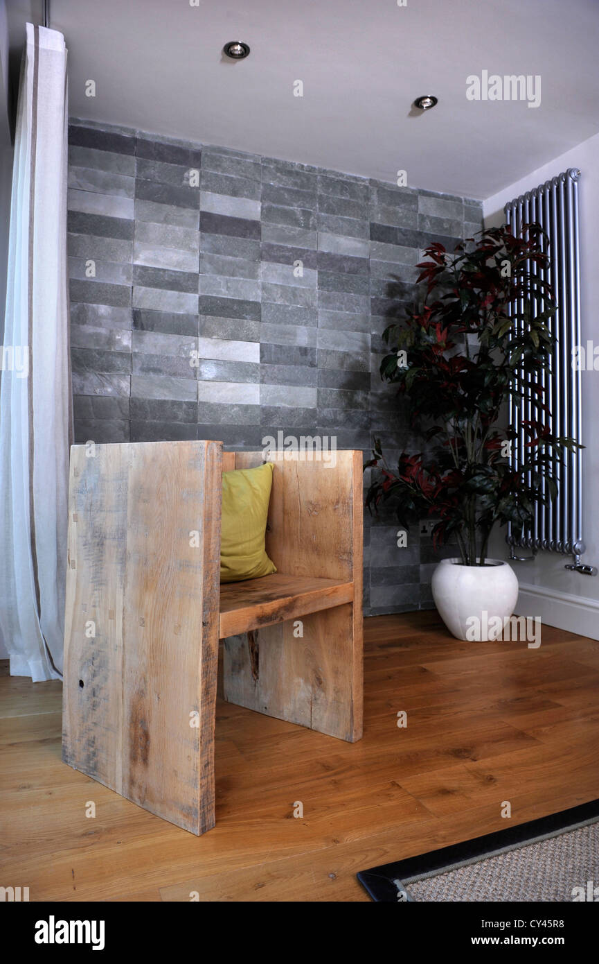 Solid wood rustic chair at a modern luxury holiday home near Abersoch on the Lleyn Peninsula in North Wales UK Stock Photo