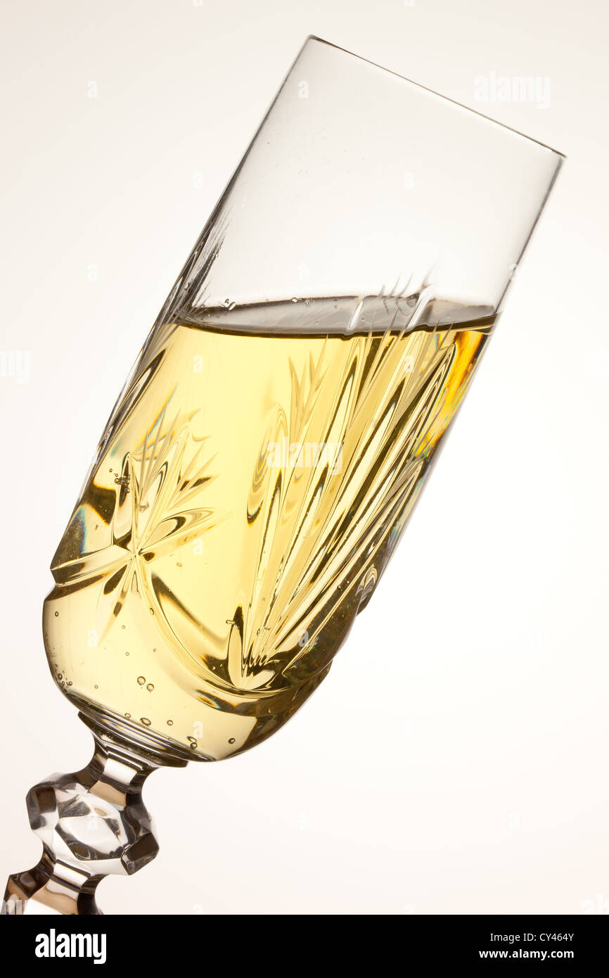 A tilted glass of vintage champagne toasting Stock Photo Alamy