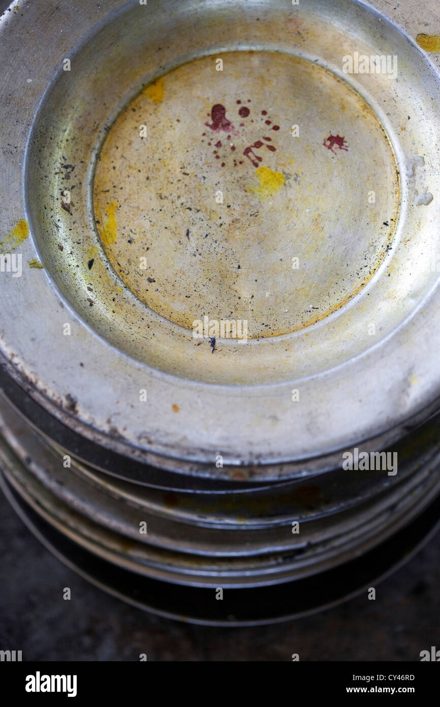 Used plates in the kitchen where a Wazwan feast has been prepared, Srinagar, Kashmir Stock Photo