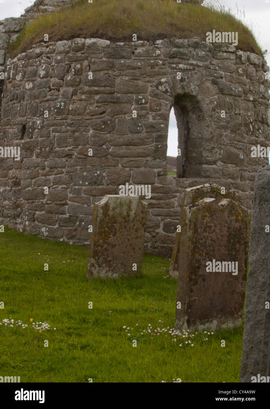 Ruins of Round Kirk at Orphir, Scotland built by Earl Hakon in 11th century and a few tomb stones are seen. Stock Photo