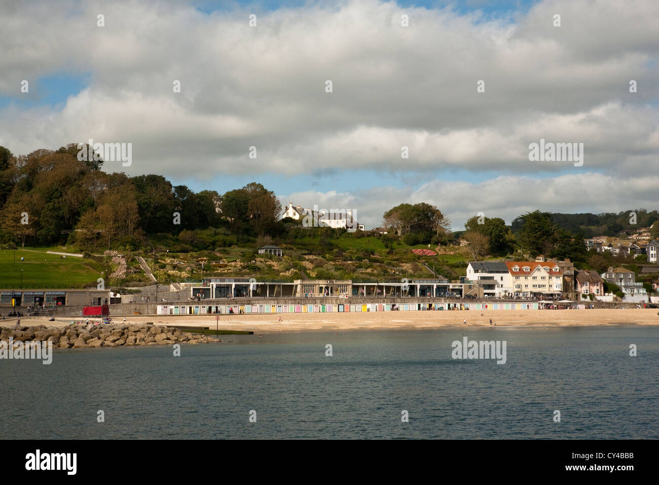 summer day in Lyme Regis looking toward the beach huts from the cobb Stock Photo