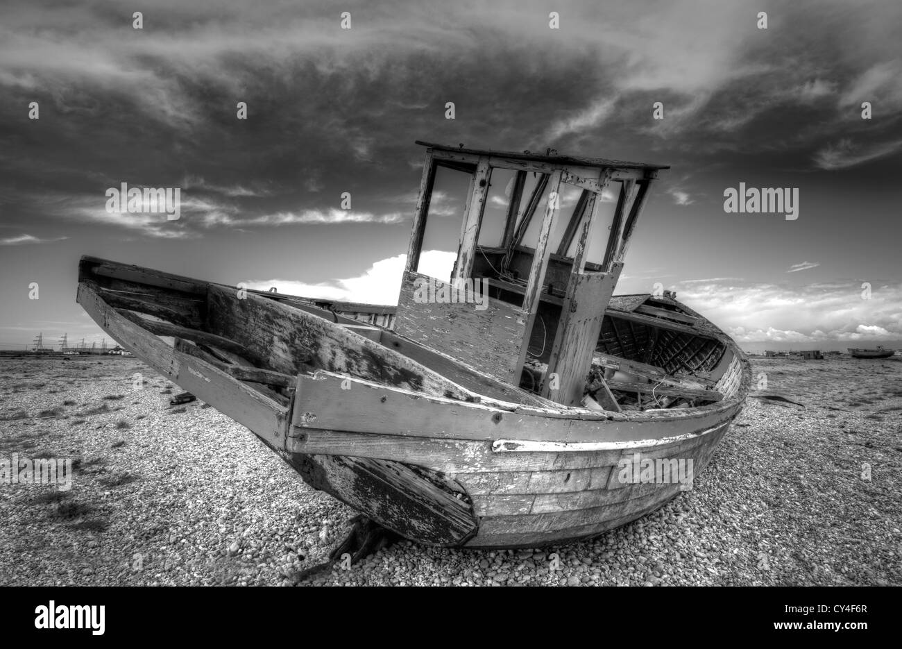 An abandoned fishing boat lies decaying on the shingle beach on ...