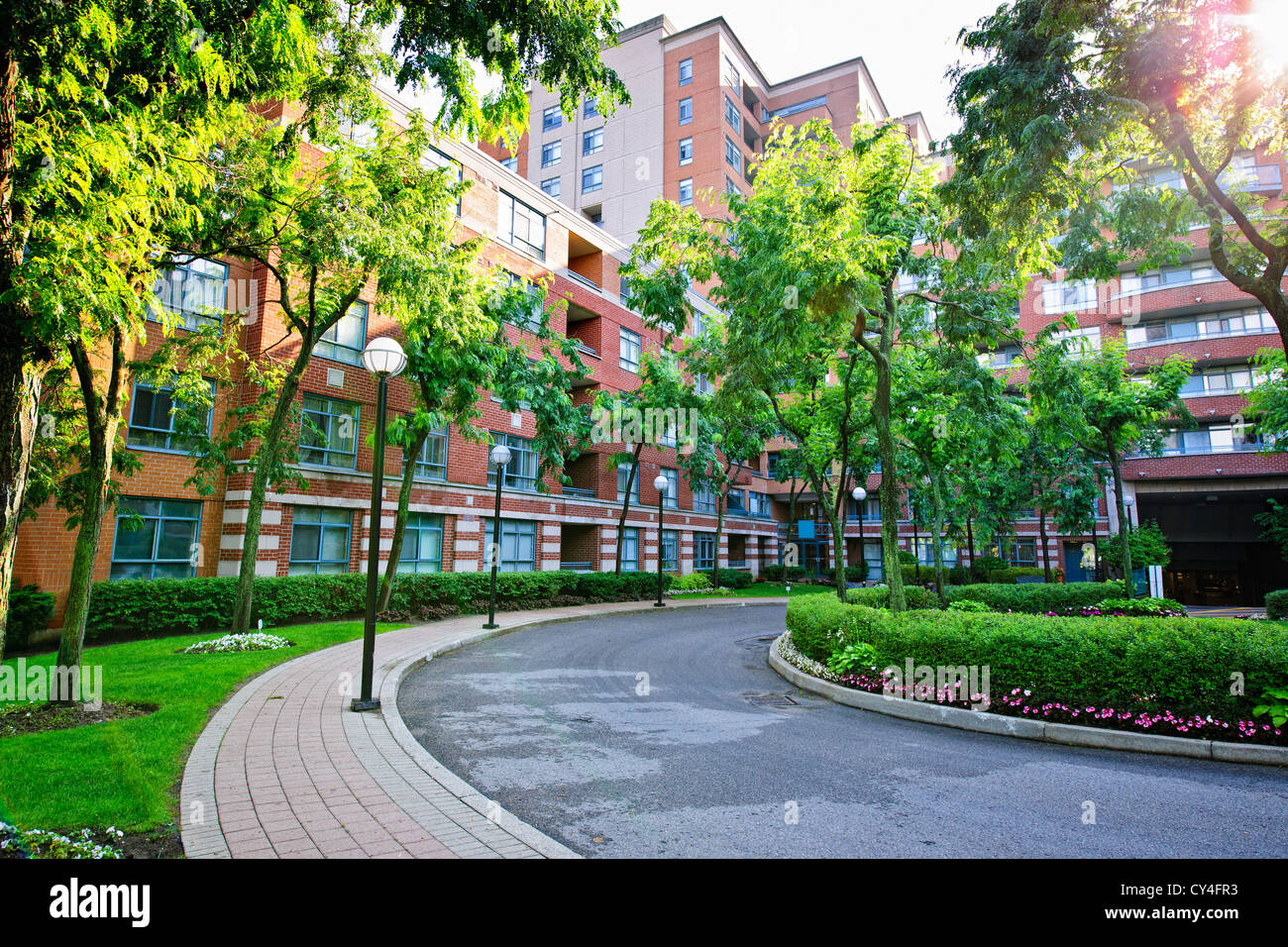 Circular driveway and sidewalk at brick condominium building Stock Photo