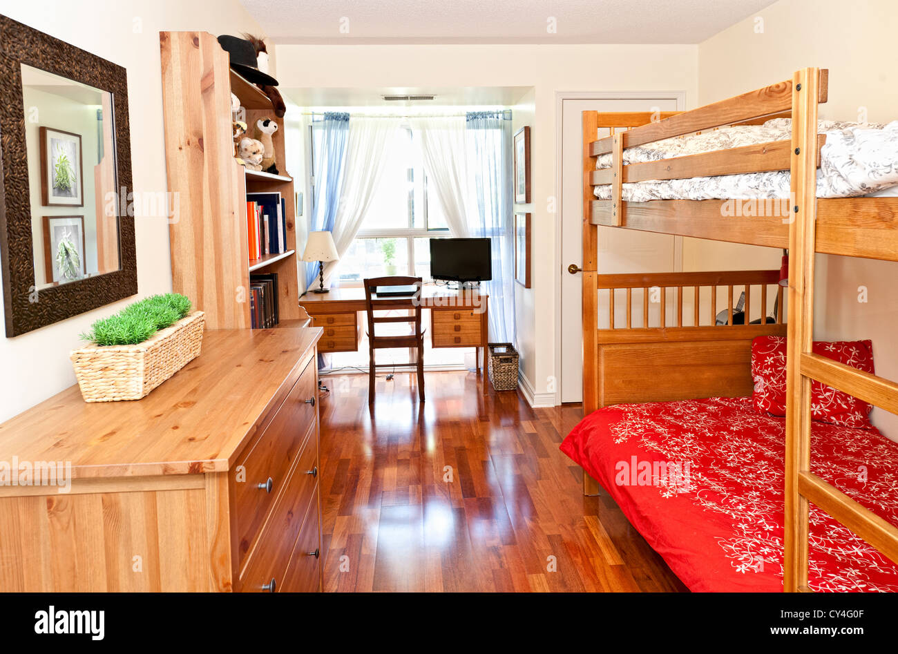 Student bedroom with hardwood floor and bunk beds - artwork is from photographer portfolio Stock Photo