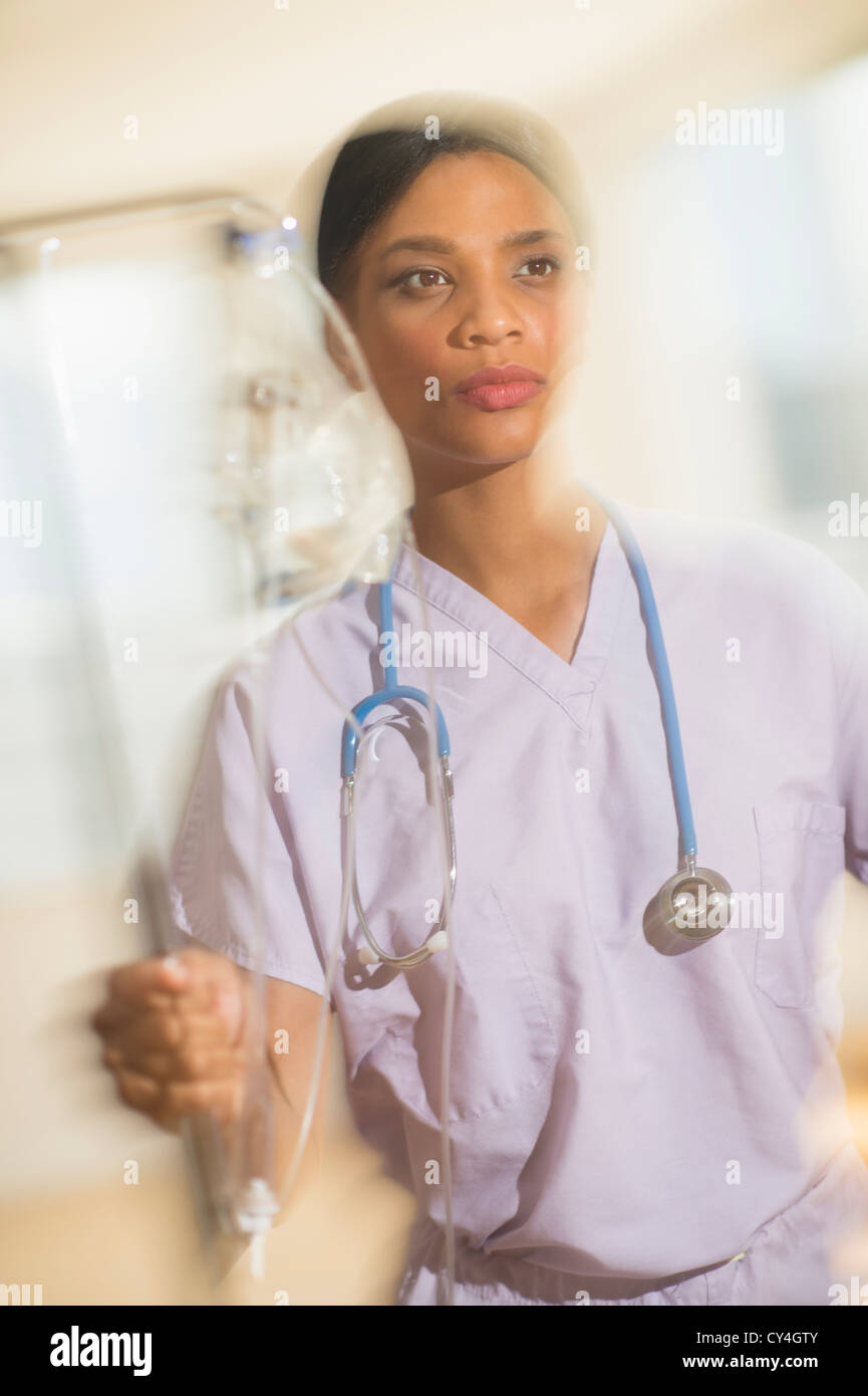 USA, New Jersey, Jersey City, Female doctor rushing with iv drip Stock