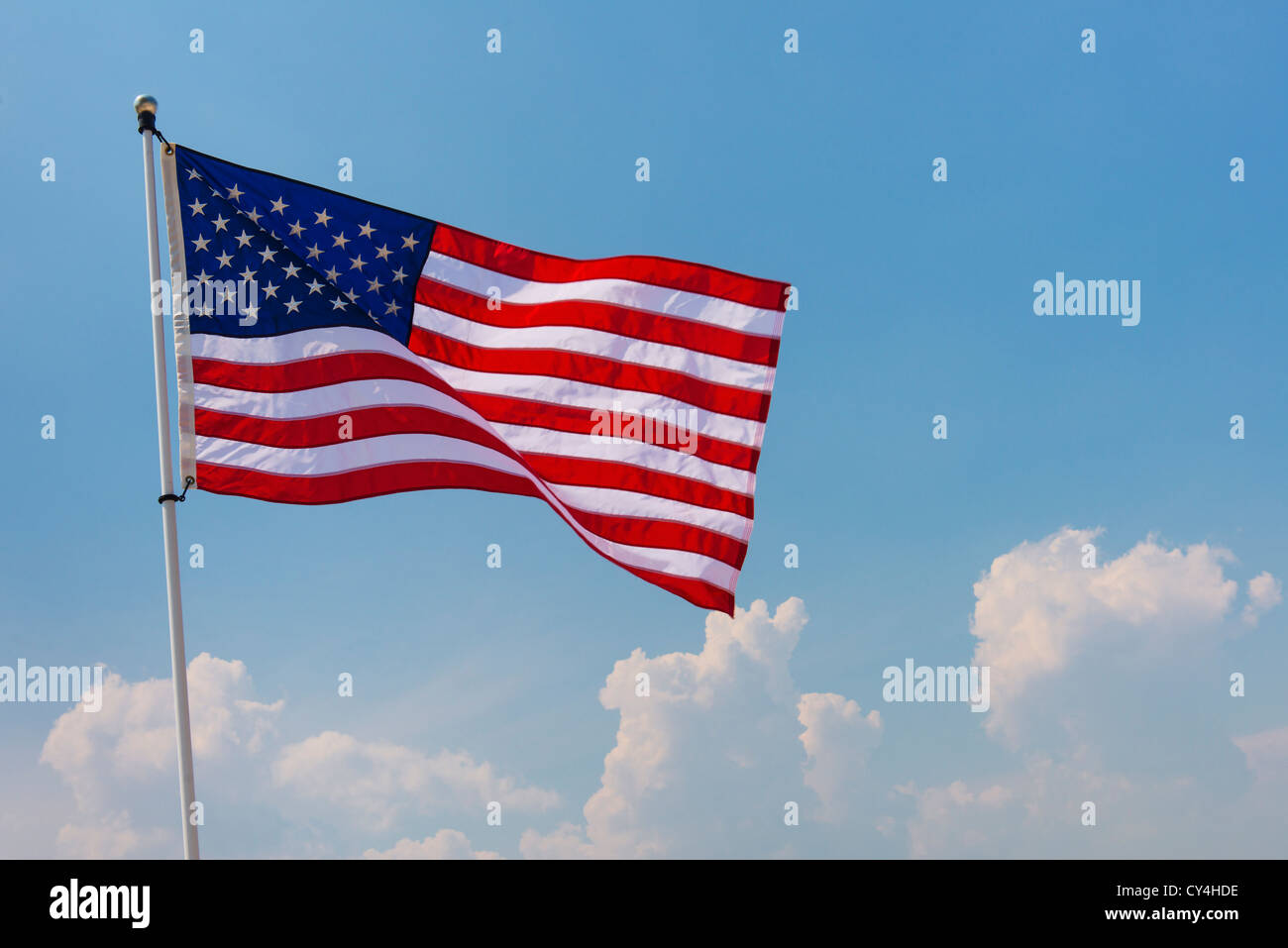 USA, New Jersey, Jersey City, US flag against blue sky Stock Photo