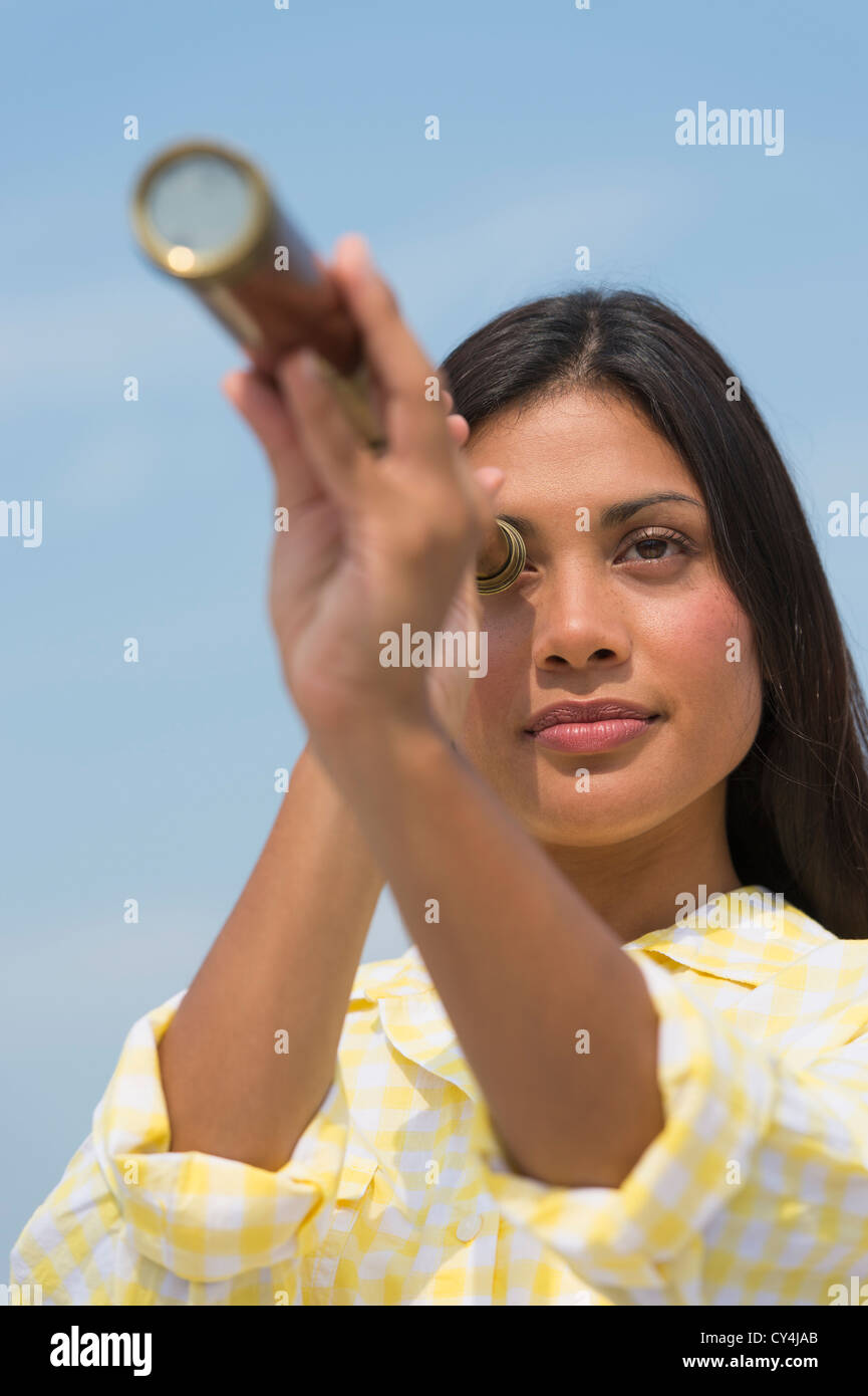 USA, New Jersey, Jersey City, Woman looking through telescope Stock Photo