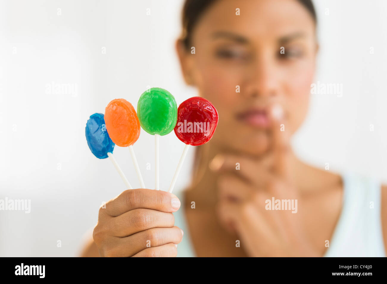 Woman holding colorful lollypops Stock Photo