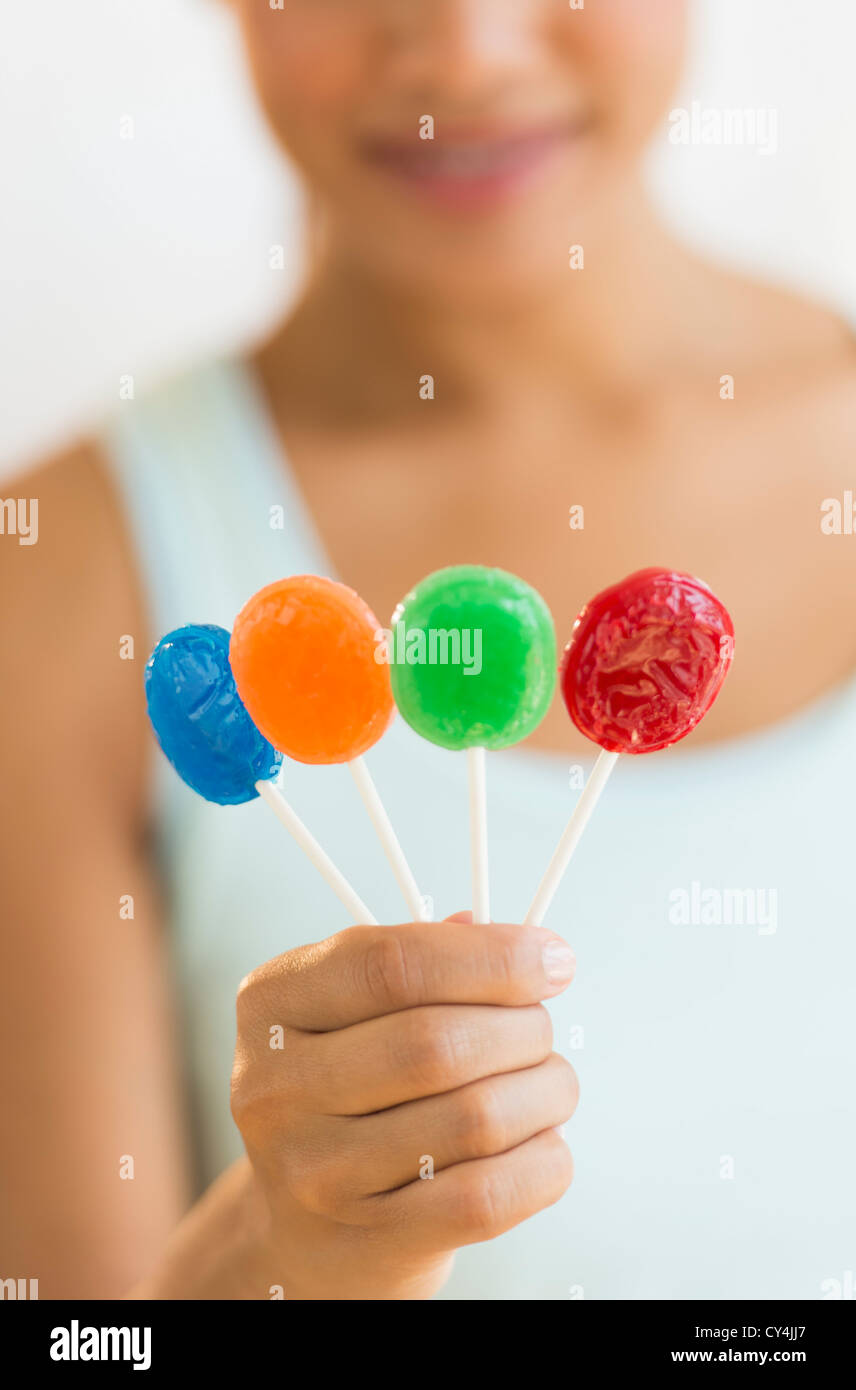 Woman holding colorful lollypops Stock Photo