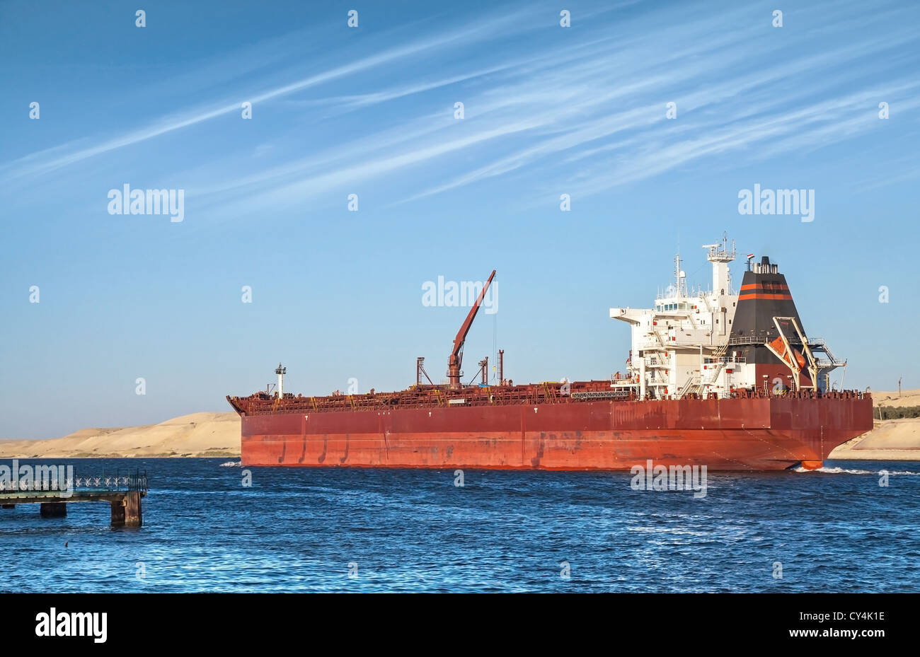 Big red oil tanker passes through the Suez Canal Stock Photo