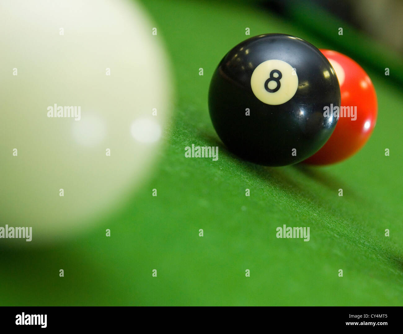 8-ball blocking shot on ball in game of pool Stock Photo