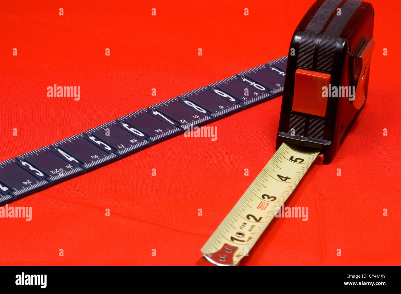 Measuring tape and ruler on red background Stock Photo