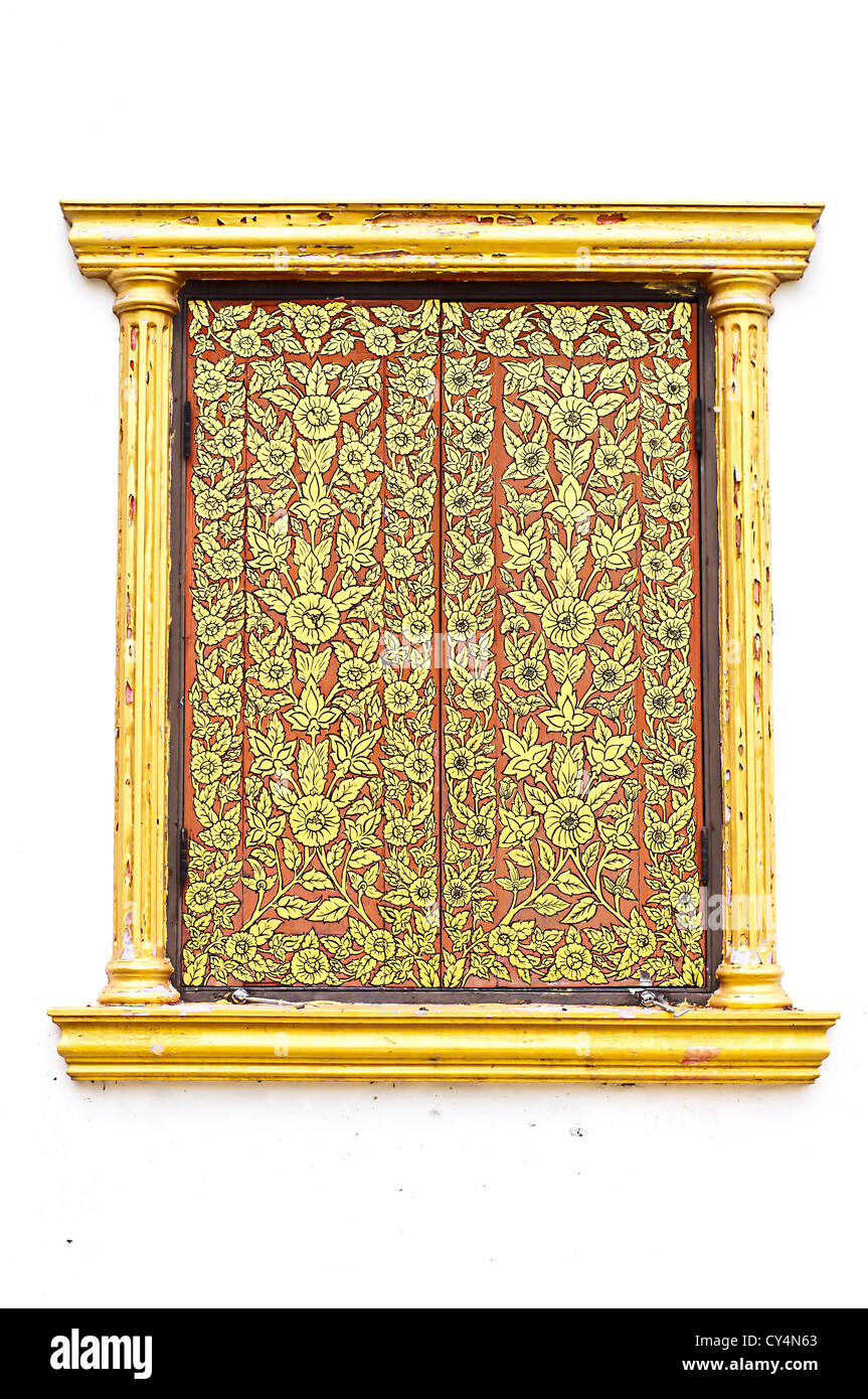 Ancient Golden carving wooden window of Thai temple in Thailand. Stock Photo