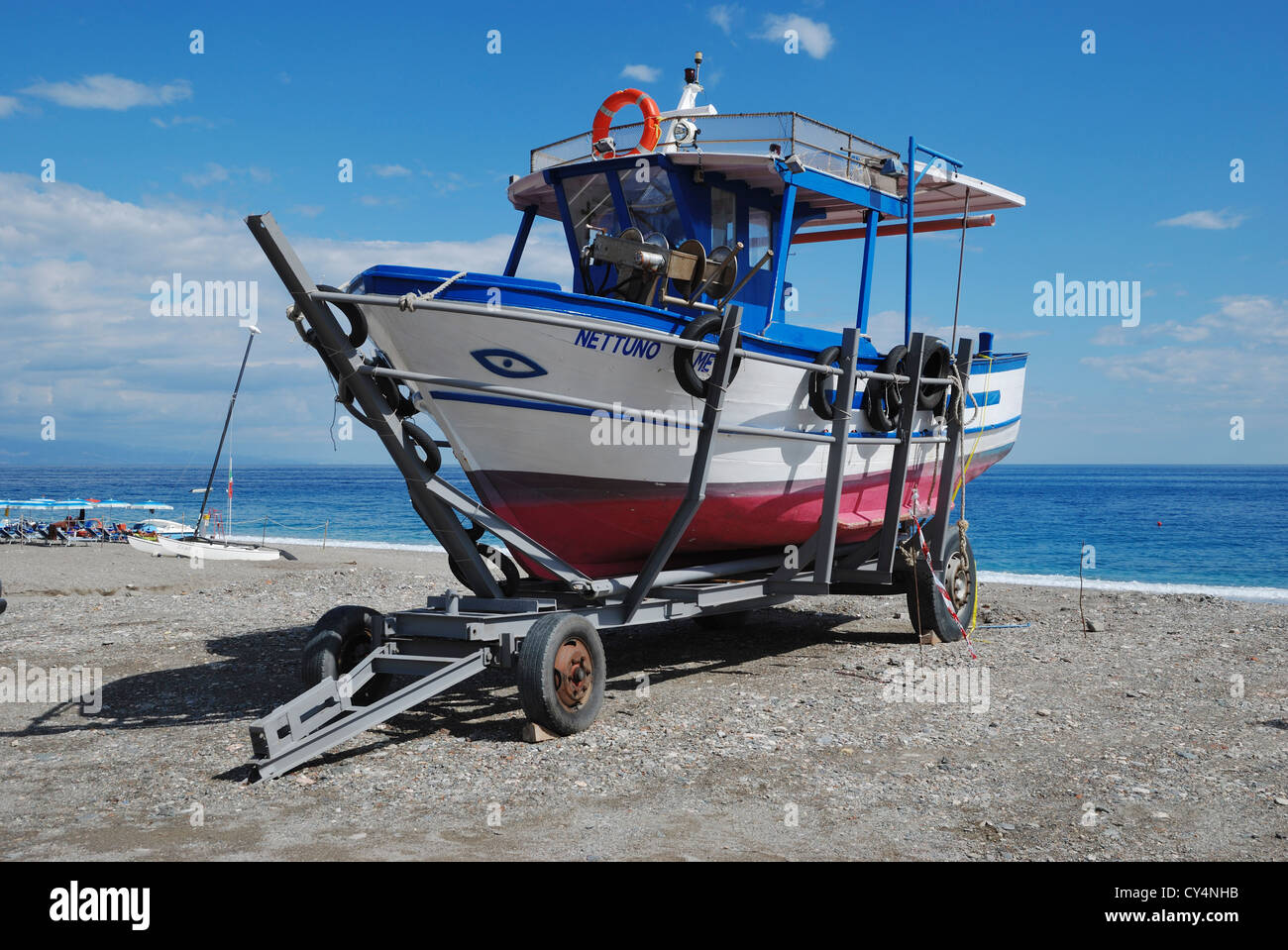 A fishing boat on the beach at Letojanni, Sicily, Italy. Stock Photo