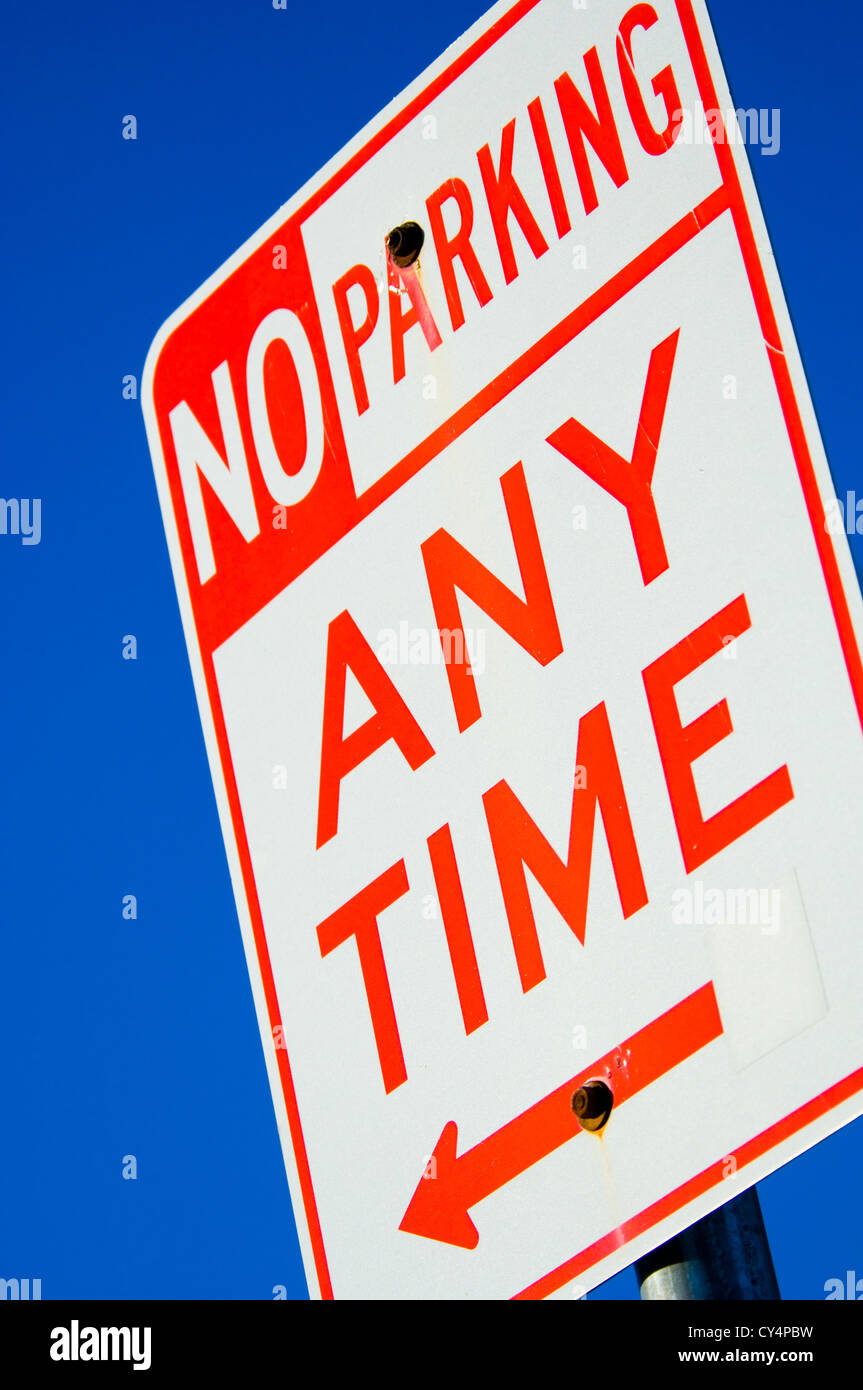 sign with no parking anytime against vibrant blue sky Stock Photo - Alamy
