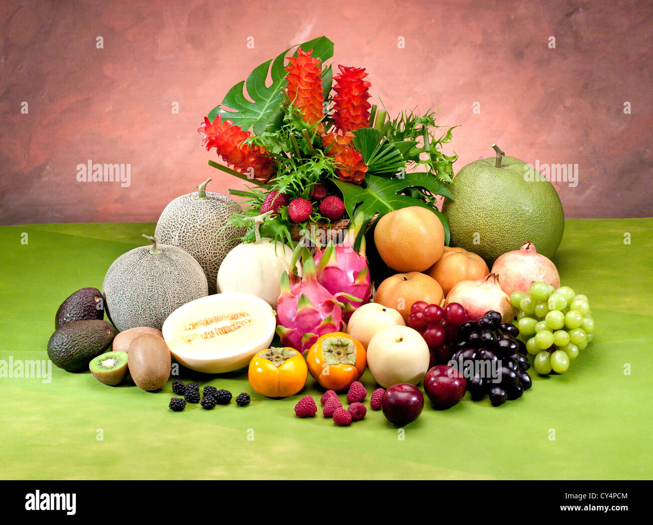 Colorful variety of worldwide fruits better for health on the green background Stock Photo