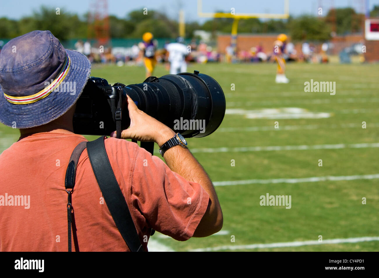 Professional Sports Photographer working youth American football game Stock Photo