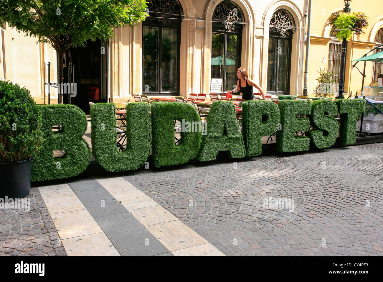 Fake topiary bushes spelling the word Budapest outside a city