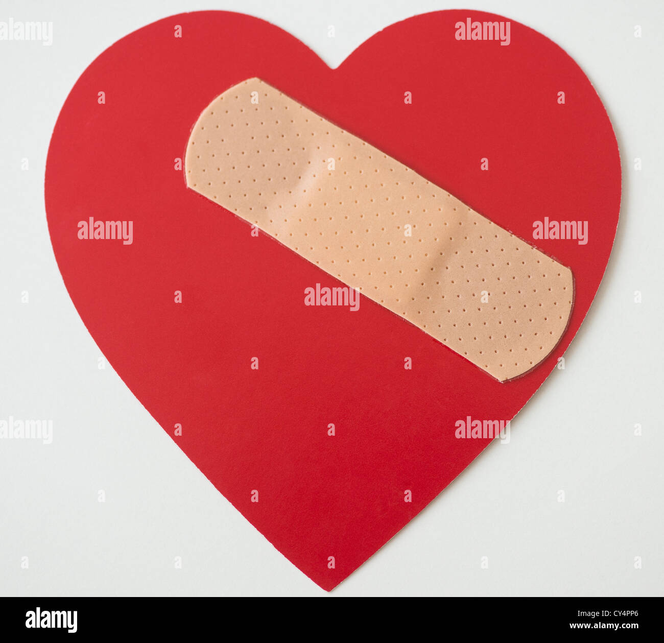Studio shot of heart with adhesive bandage Stock Photo