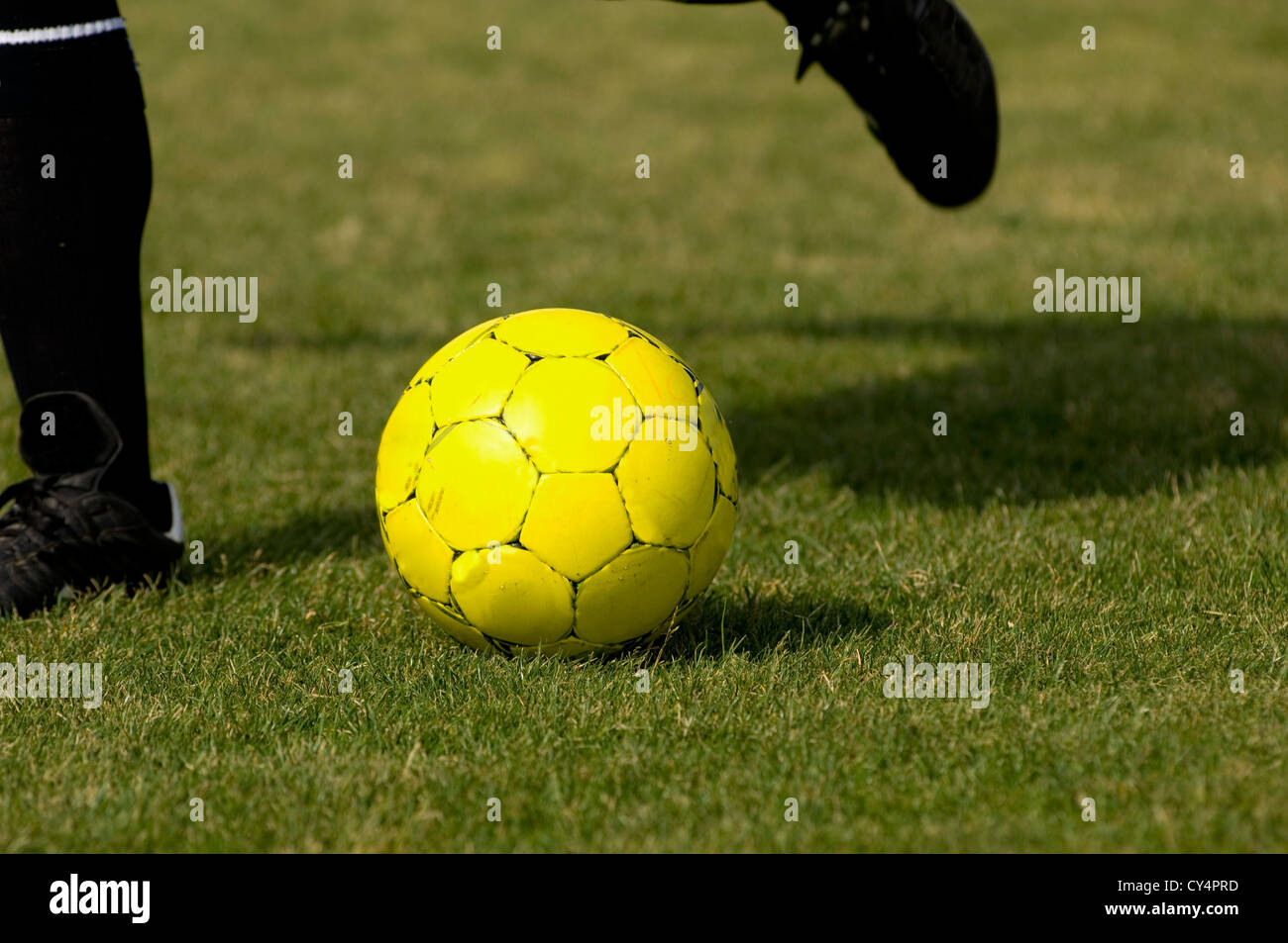 Yellow Soccer Football getting kicked Stock Photo Alamy