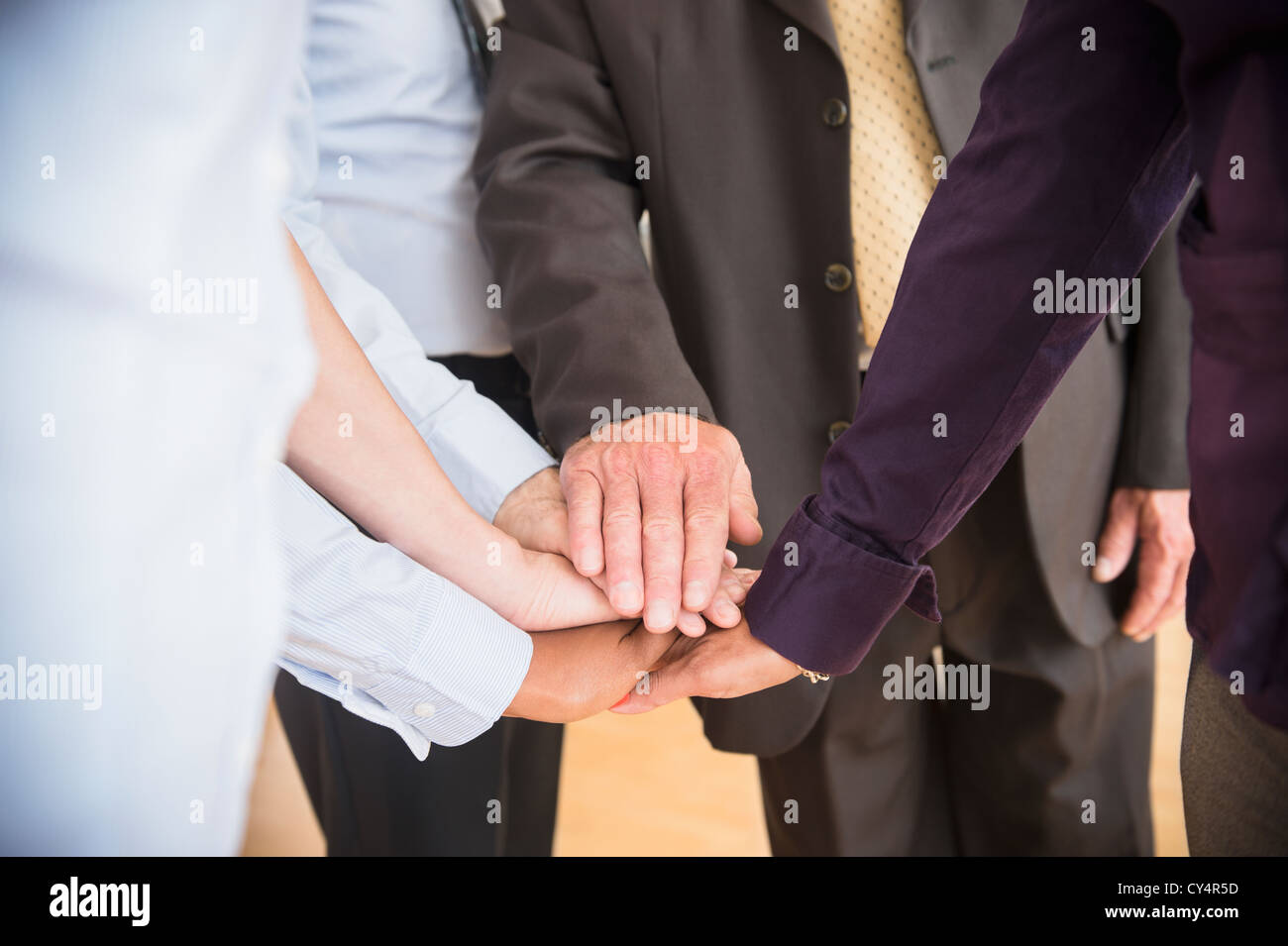 USA, New Jersey, Jersey City, Office workers holding hands Stock Photo