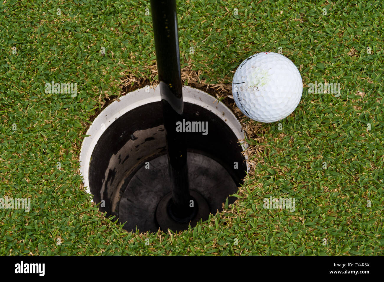 https://c8.alamy.com/comp/CY4R6X/the-golf-holes-golf-ball-close-to-the-hole-CY4R6X.jpg