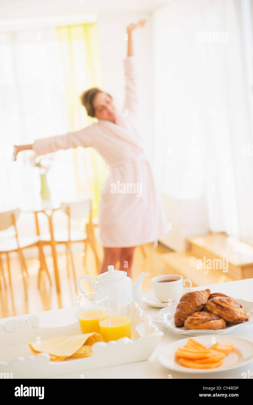 Breakfast In Robe Breakfast scene with woman in white robe stretching Stock Photo - Alamy