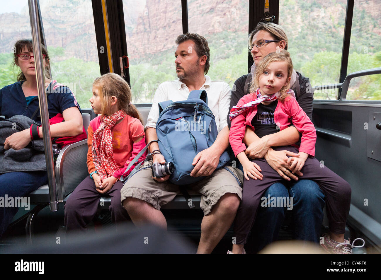 Young parents with children riding a bus/shuttle in Zion NPS Stock Photo
