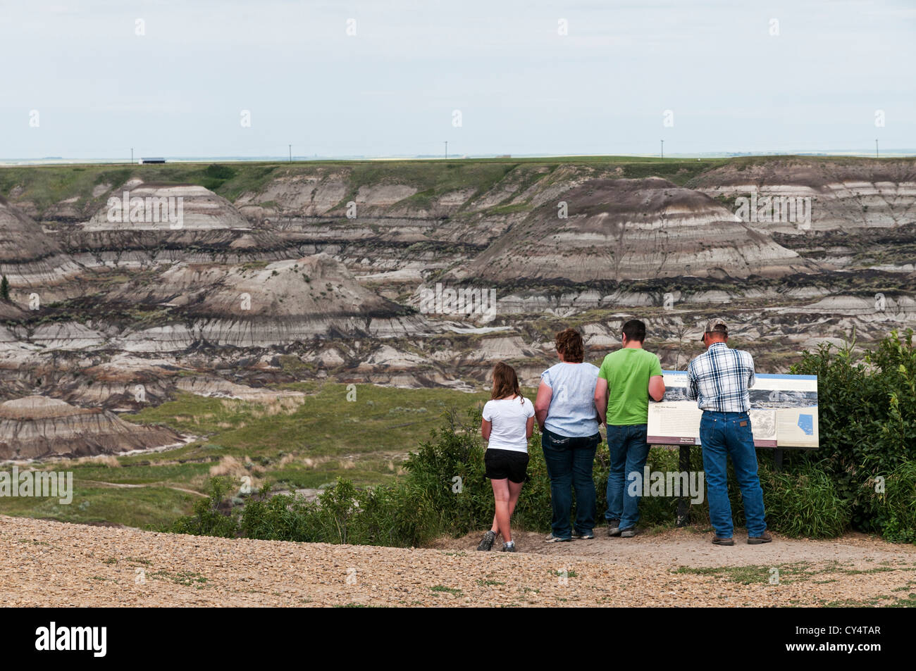 A vacationing family of four visits Horseshoe Canyon located in Alberta Canada's badlands near the town of Drumheller. Stock Photo