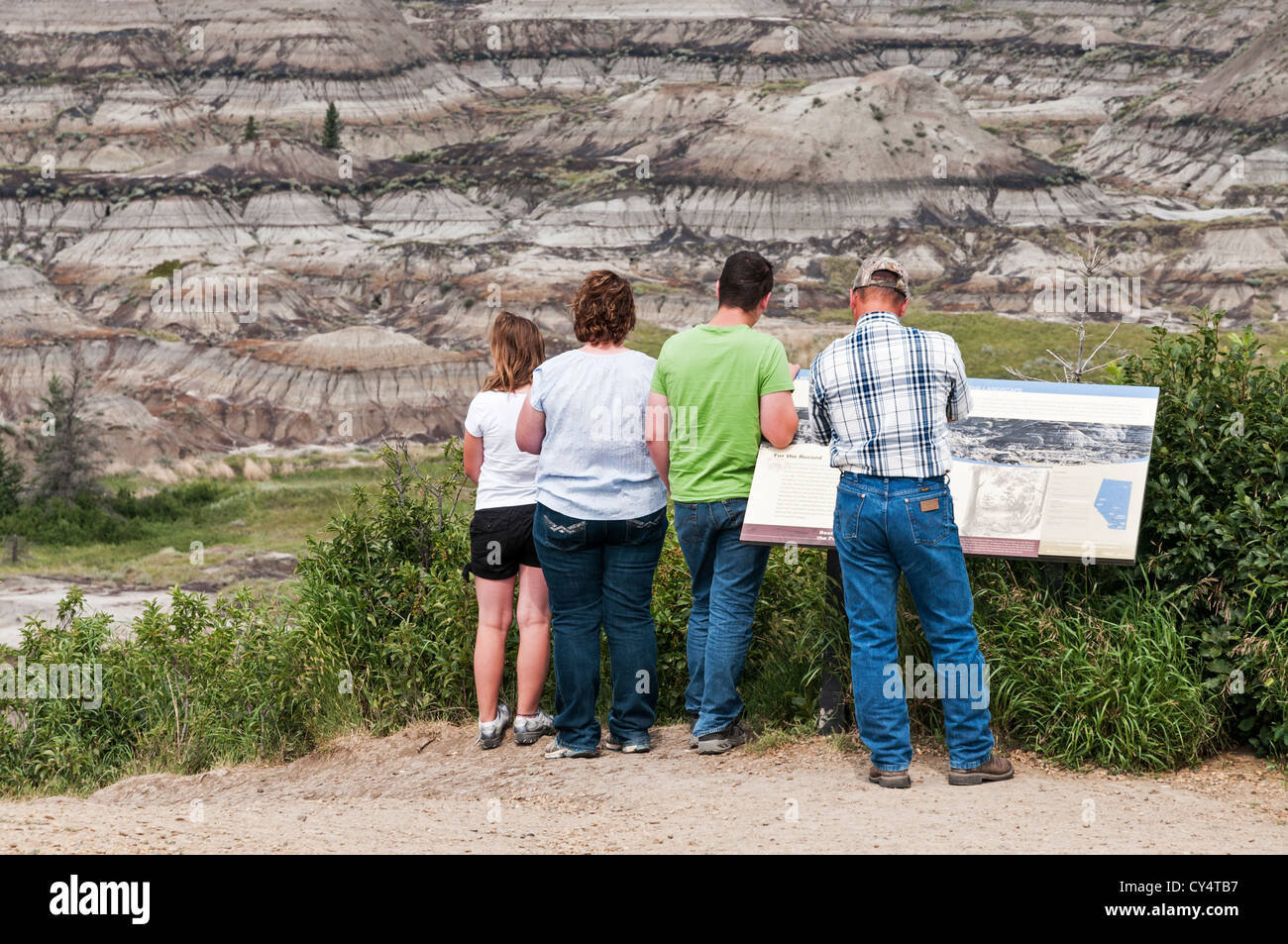 A vacationing family of four visits Horseshoe Canyon located in Alberta Canada's badlands near the town of Drumheller. Stock Photo