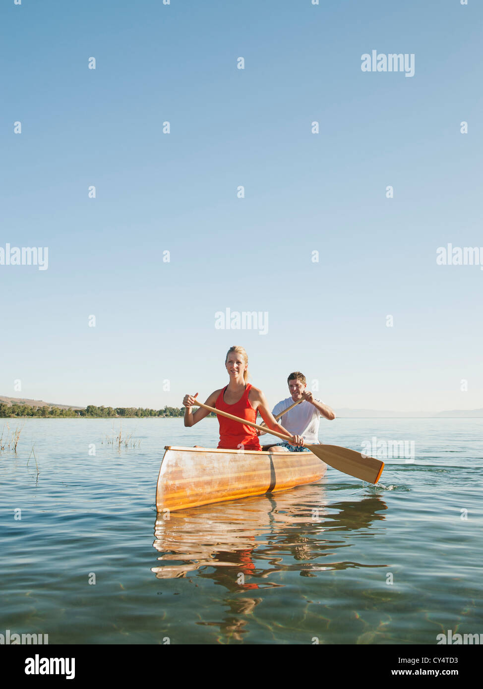 USA, Utah, Garden City, portrait of two young people paddling canoe Stock Photo