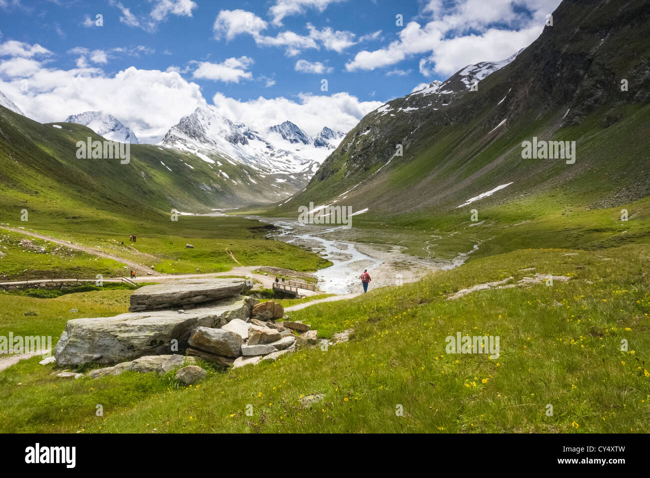 Hikers walking in the Gaisbergtal valley on a sunny day in the Austrian Alps. Stock Photo