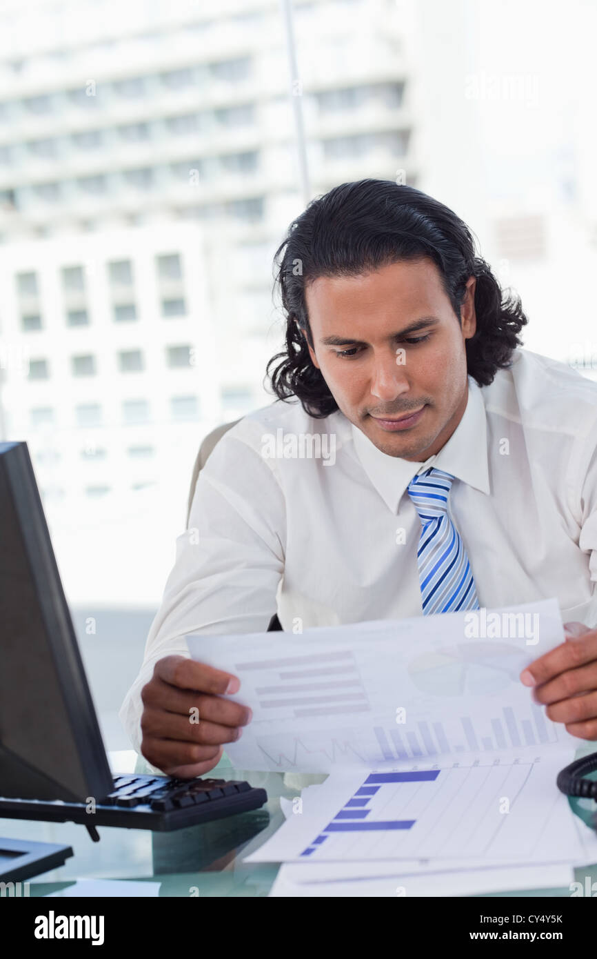 Portrait of a businessman looking at statistics Stock Photo
