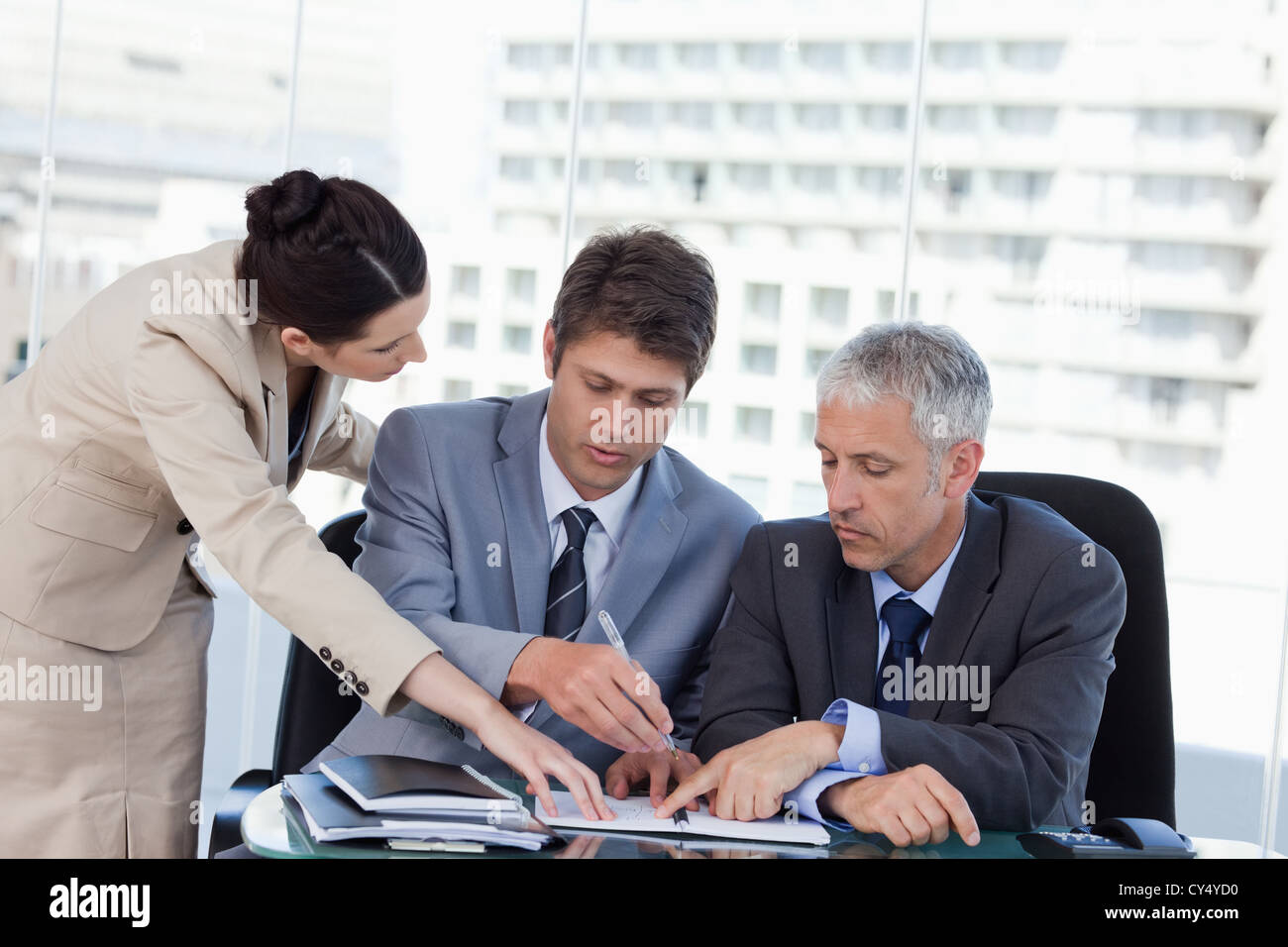 Serious business team working together Stock Photo - Alamy