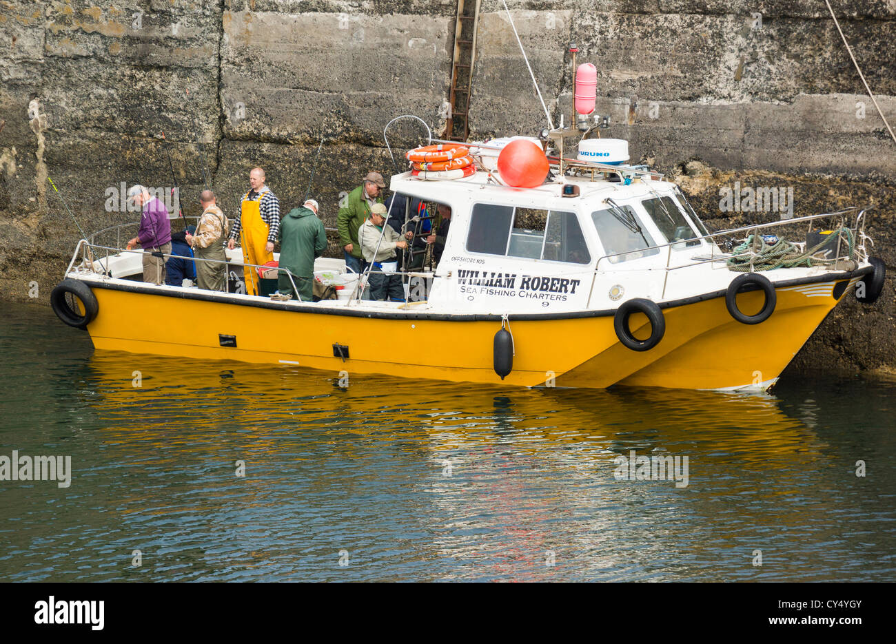 Fishermen preparing for a trip out to sea at Craster harbour in Northumberland England. Stock Photo