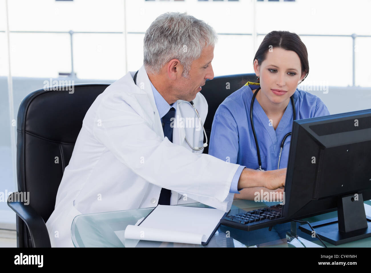 Medical team working together with a computer Stock Photo - Alamy