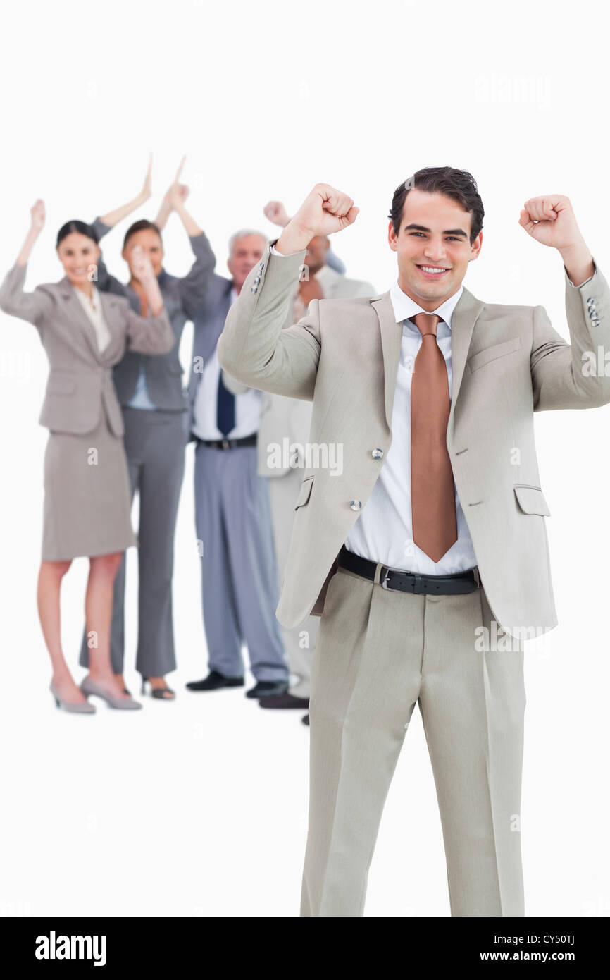 Cheering businessman with team behind him Stock Photo - Alamy