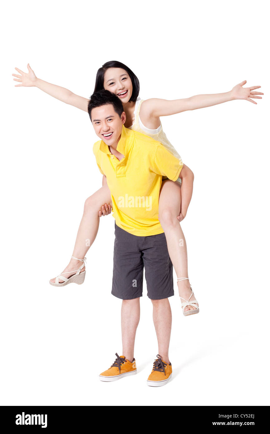 Happy young couple playing piggyback Stock Photo - Alamy