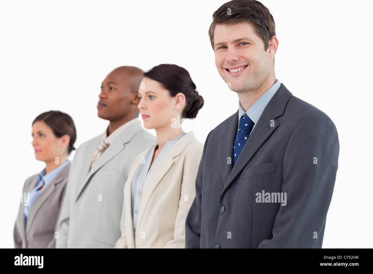 Smiling businessman standing next to his team Stock Photo - Alamy
