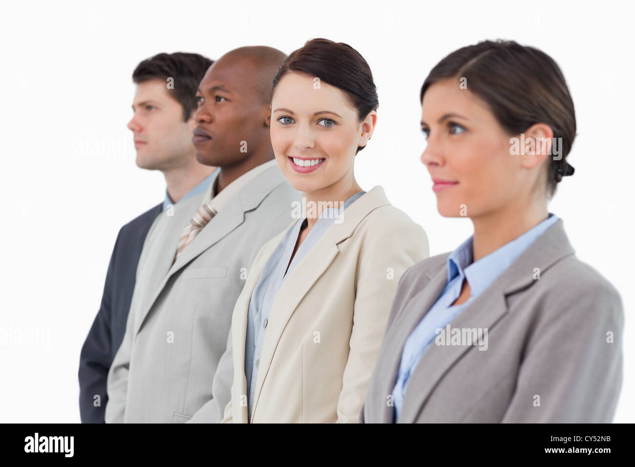 Smiling saleswoman standing between her associates Stock Photo