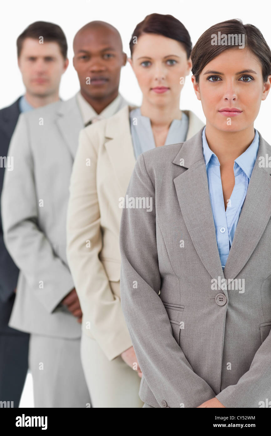 Serious looking business team standing together Stock Photo - Alamy