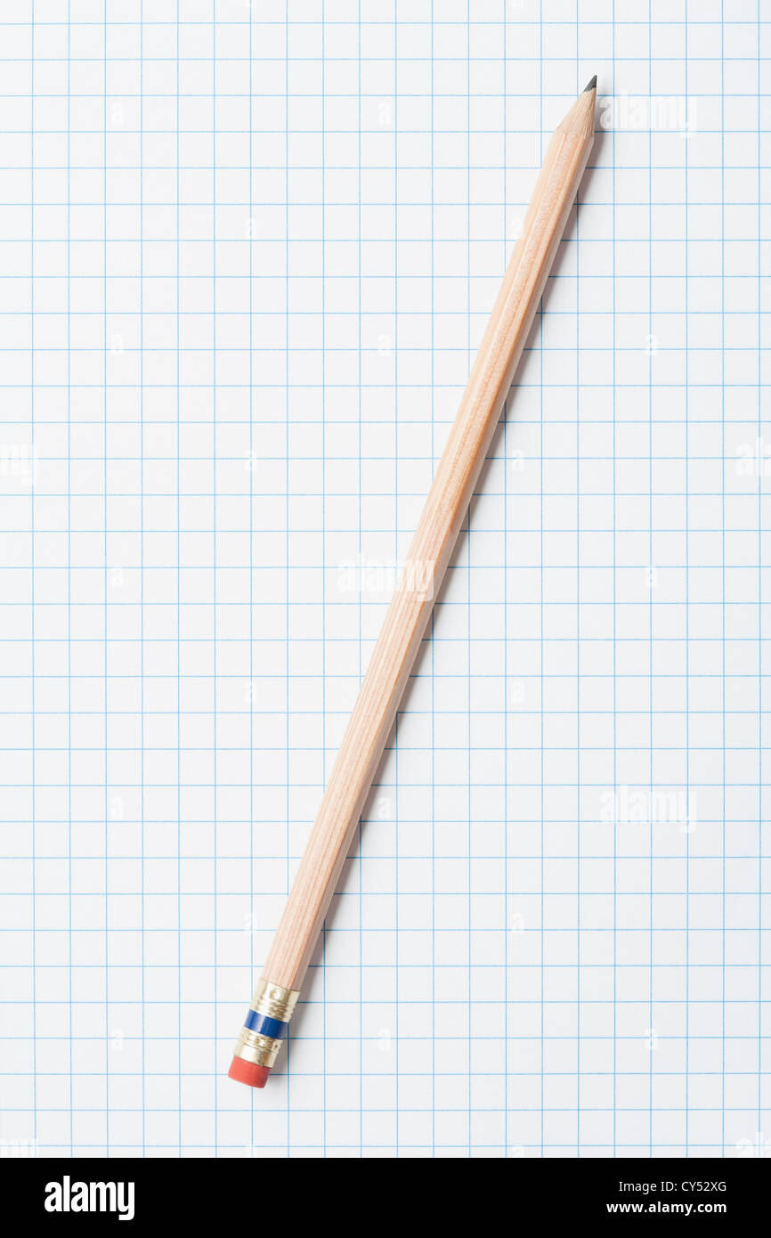 Single wooden sharpened pencil on graph paper Stock Photo