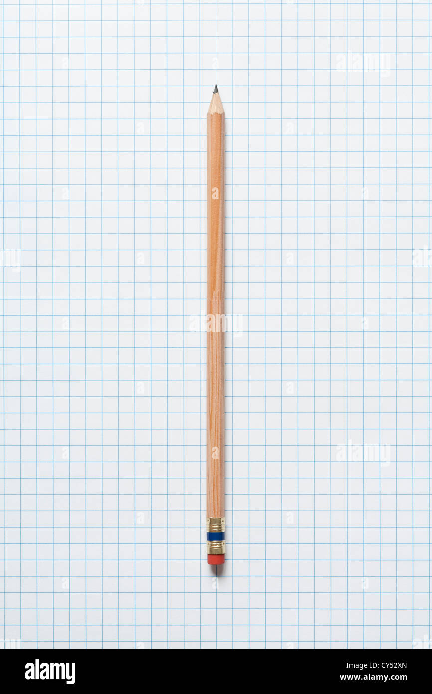 Single wooden sharpened pencil on graph paper Stock Photo