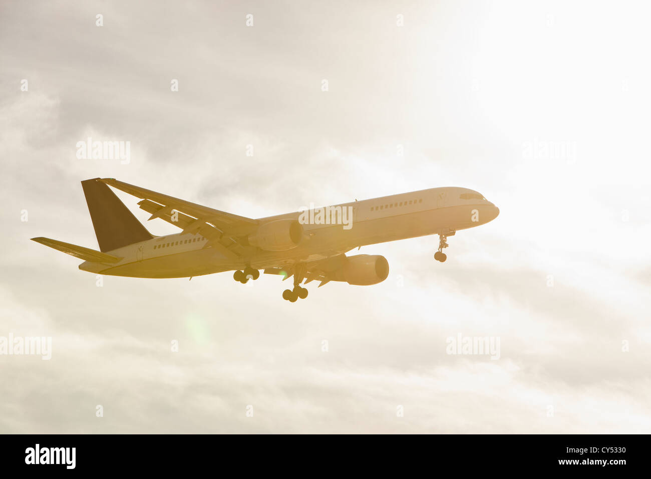 Commercial jet flying through air Stock Photo